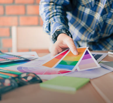 Pixecart is a creative marketplace that provides freelance graphic and design services on demand. This image is showing a graphic designer working with colour pantone charts.